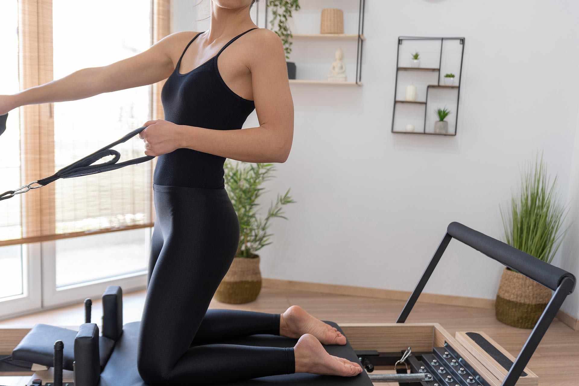 young-woman-exercising-on-pilates-reformer-bed-2021-08-26-15-59-35-utc-(2)