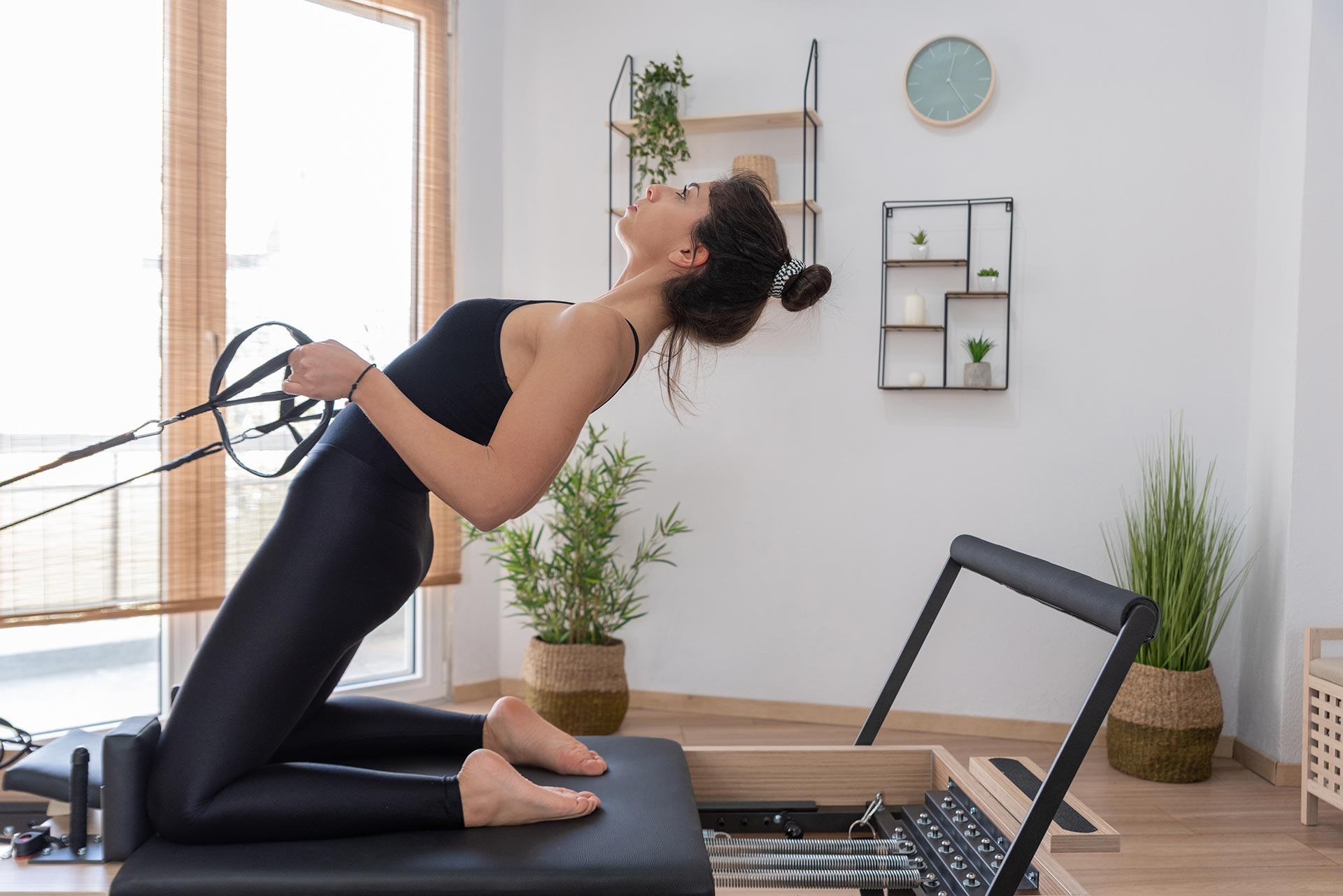 young-woman-exercising-on-pilates-reformer-bed-2021-08-26-15-59-35-utc